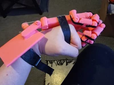 wrist actuated prosthetic arm